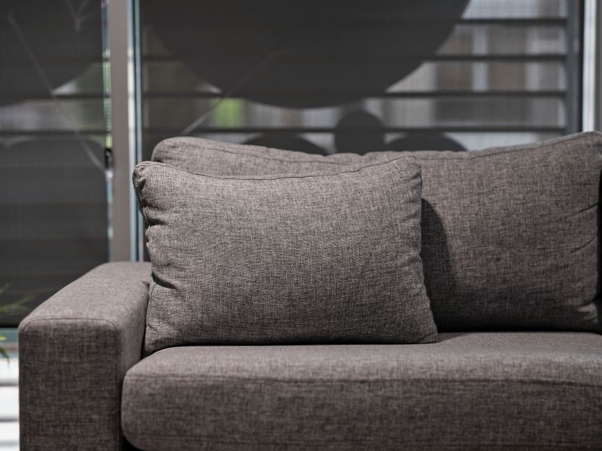 Detailed upholstery cleaning on a fabric sofa